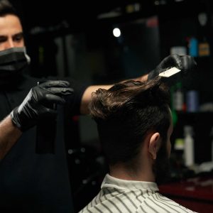 male-professional-barber-doing-hair-styling-to-han-48Y68C8-scaled.jpg